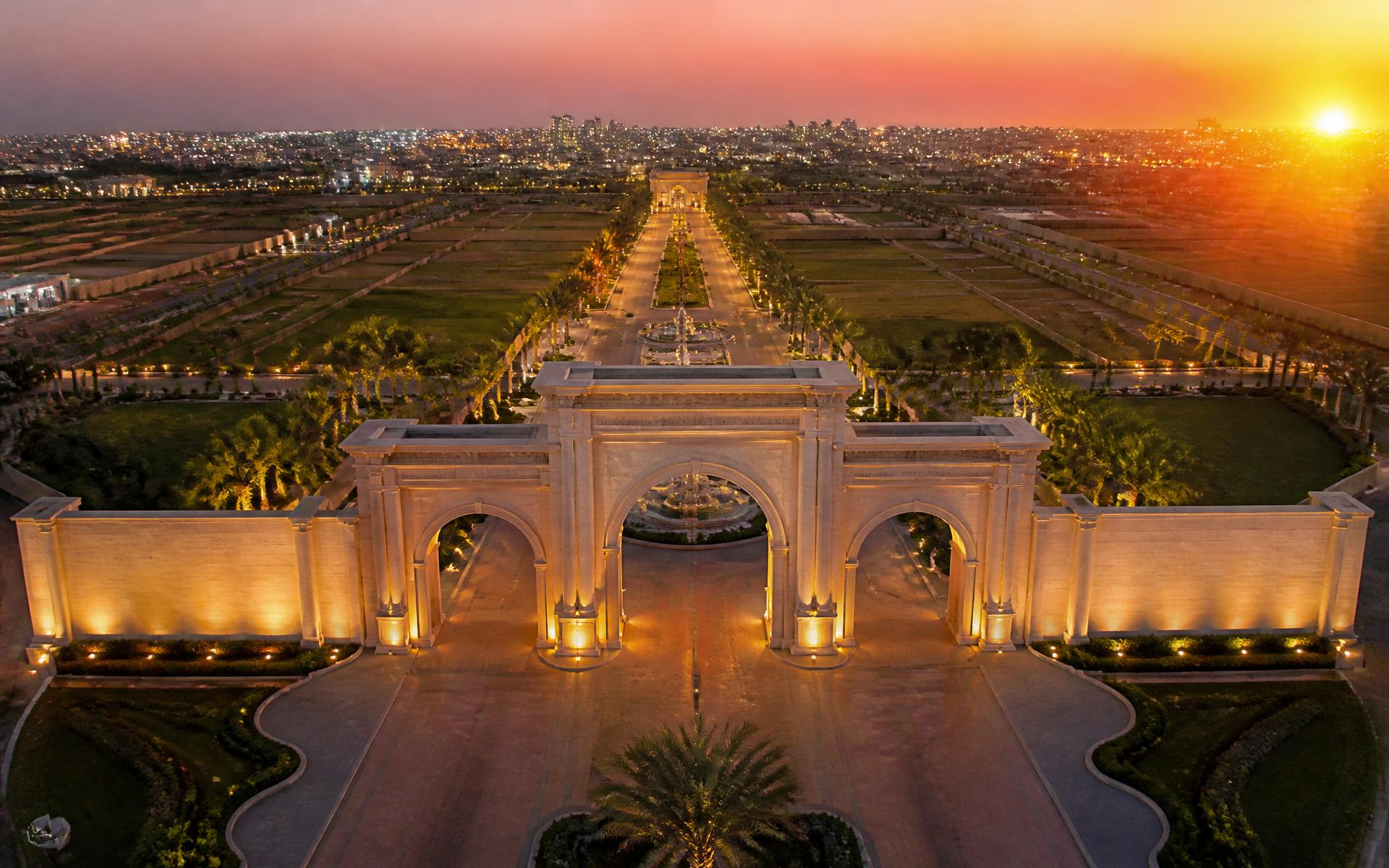 Grand ceremonial entrance of a premium plotted development at golden hour